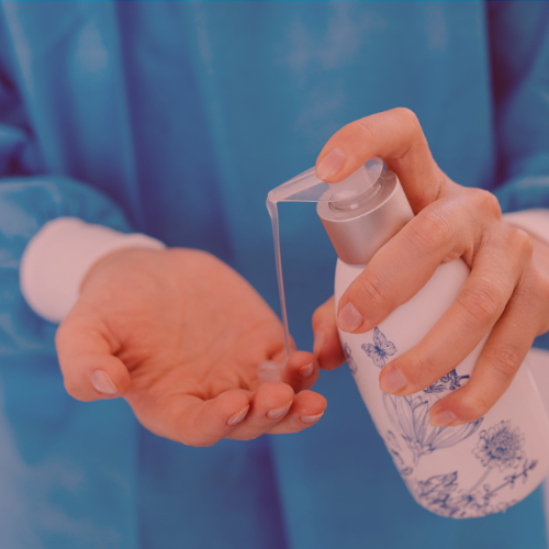 Close-up of hands dispensing liquid soap from bottle onto the palm,, conveying cleanliness.