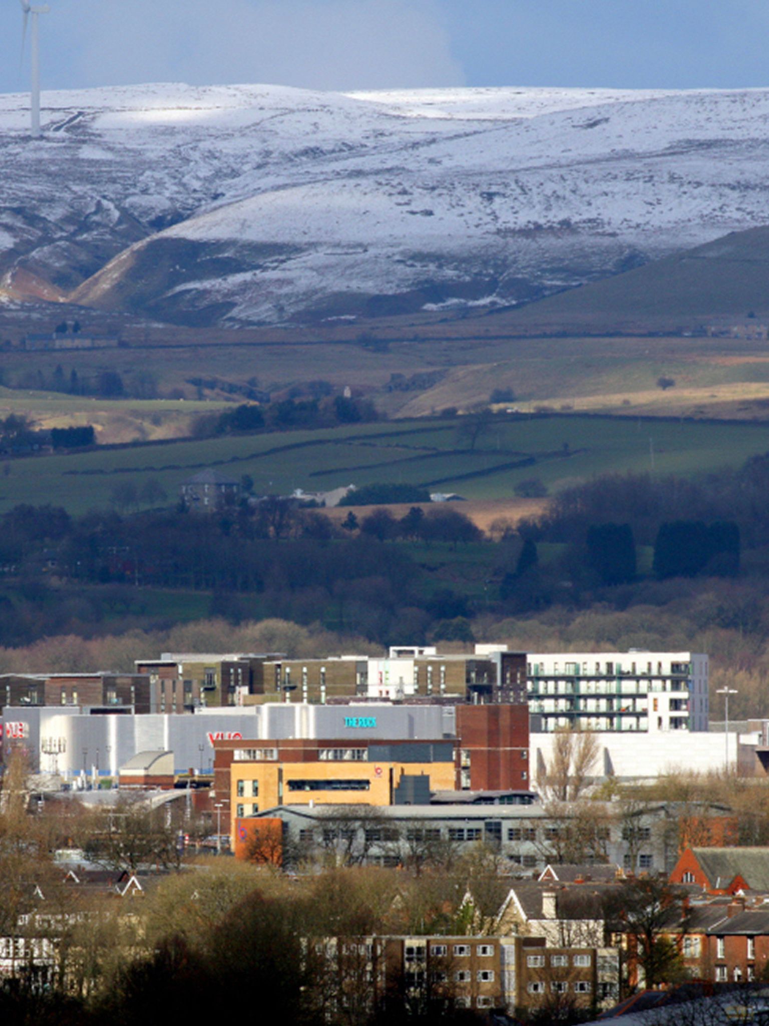 the rock shopping centre in the foreground with snow covered hill in the backdrop