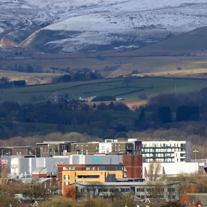 the rock shopping centre in the foreground with snow covered hill in the backdrop