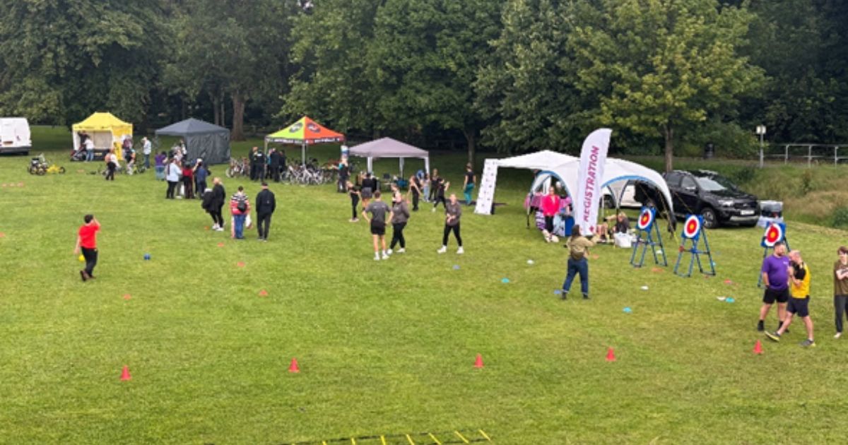 people in the park participating in various activities such as archery