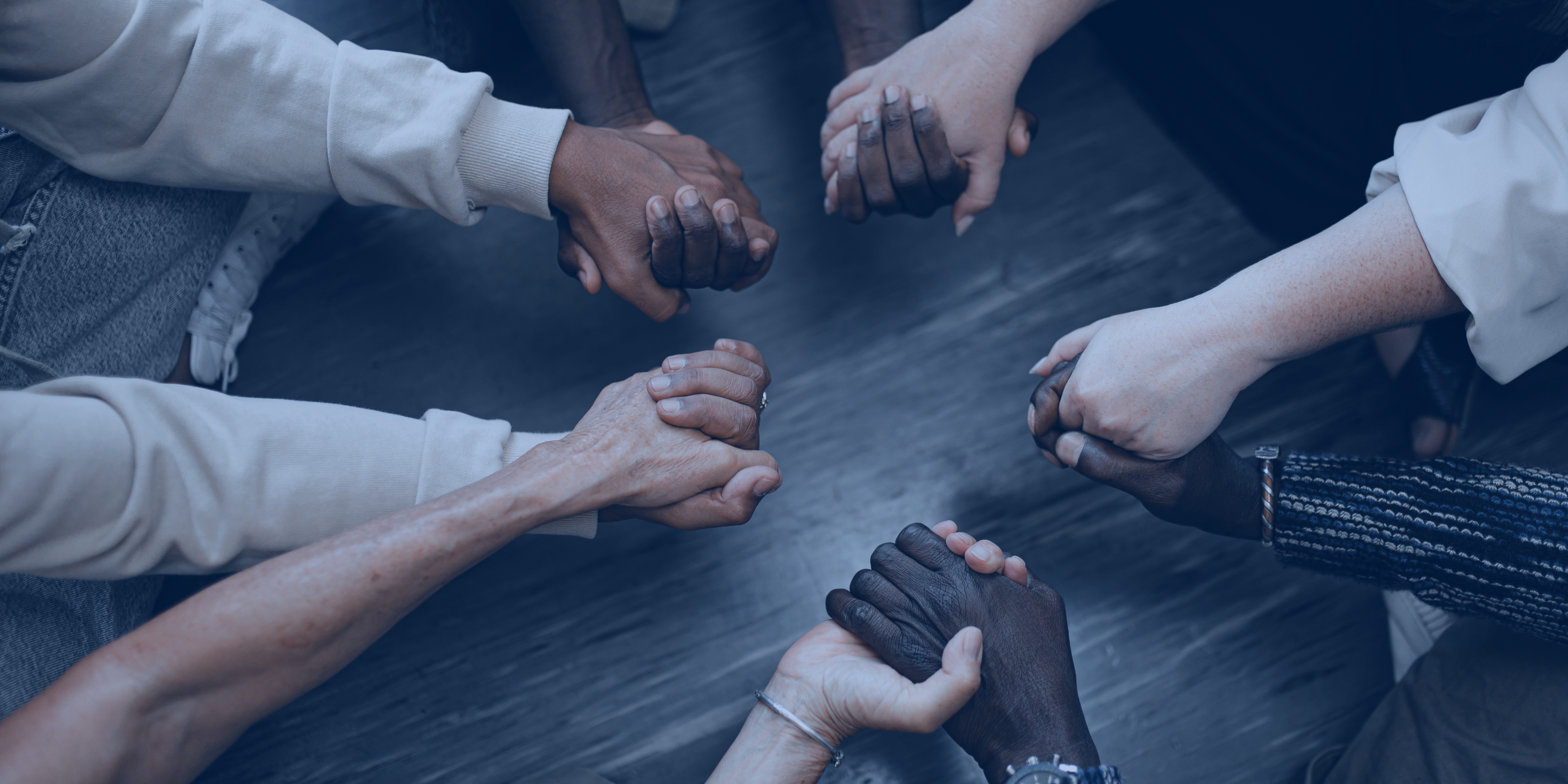 People holding hands in a circle