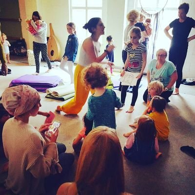 mums and children practising yoga