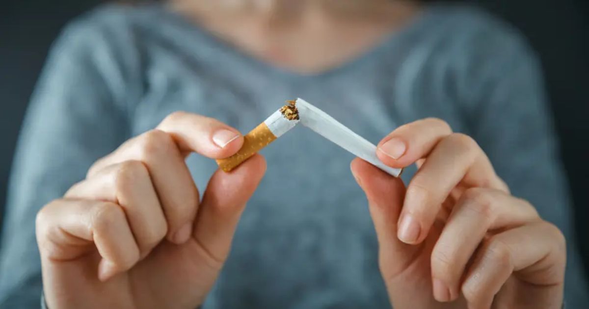 a person snapping a cigarette in a half