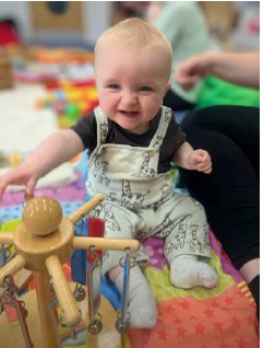 baby sat up playing with toys