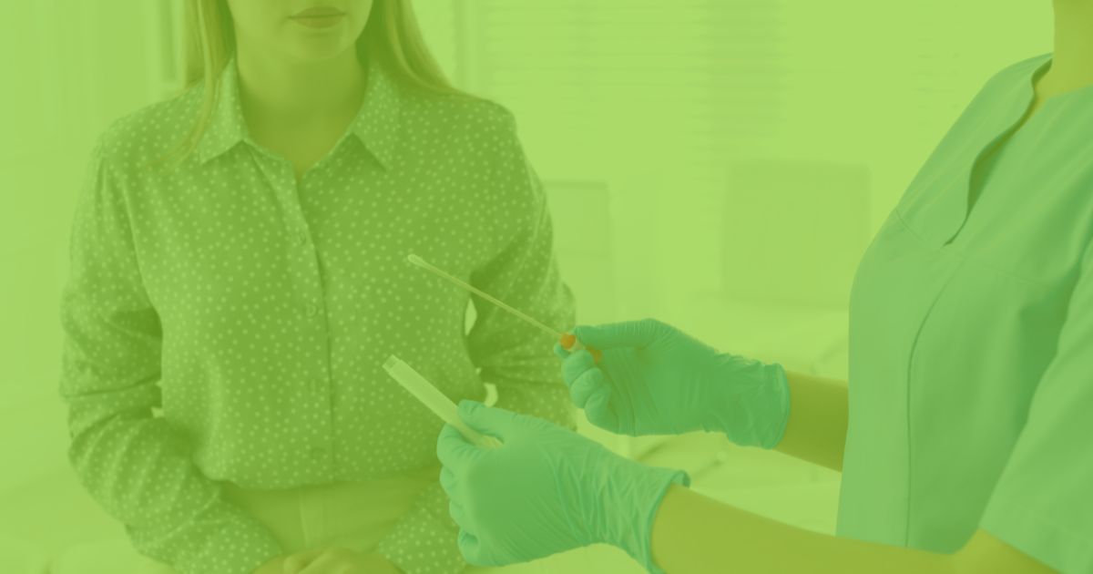A healthcare professional wearing gloves holds a swab and test tube, preparing for a medical test with a seated patient.