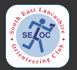 figure of man and SELOC in blue withsouth east lancashire orienteering club in red on white background 