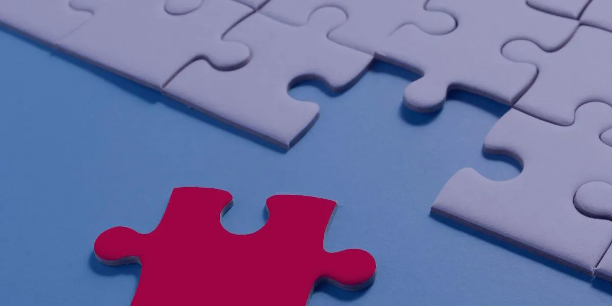 A single red puzzle piece about to complete a nearly finished jigsaw, symbolizing the importance of every part in solving a complex problem.
