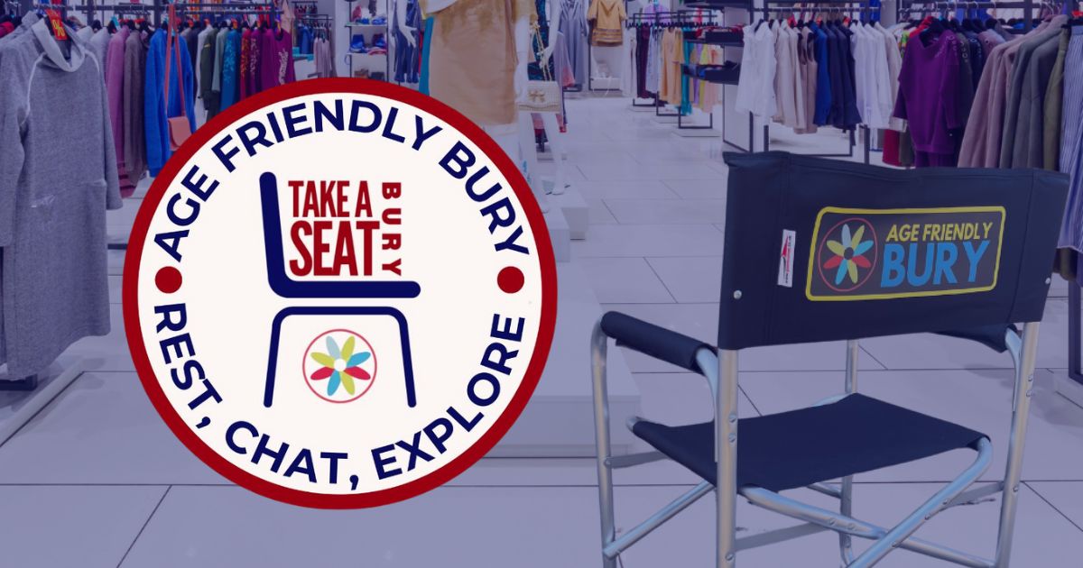 a chair printed with Age Friendly Bury positioned on a shop floor, with the Bury take A Seat logo positioned next to it