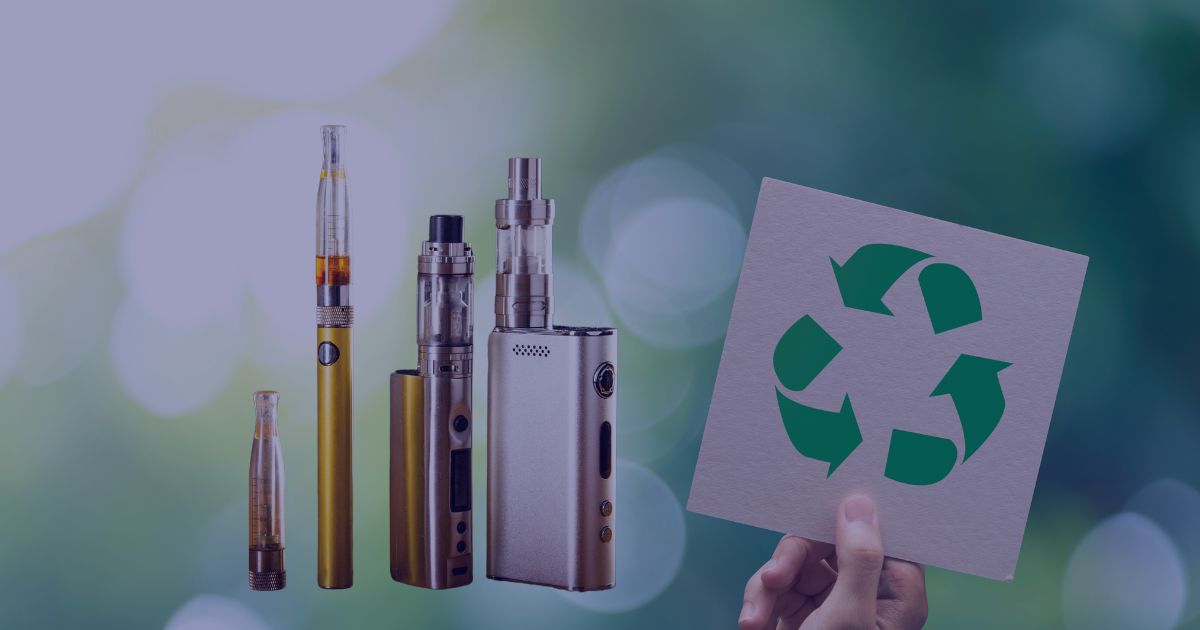 a number of vape devices placed next to a hand holding a recycling sign