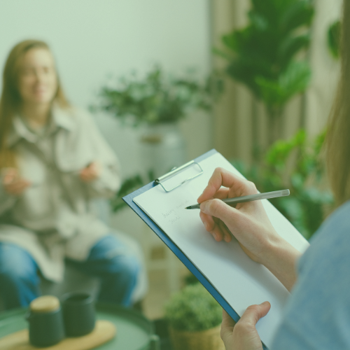 Woman with a patient and writing on a clip board