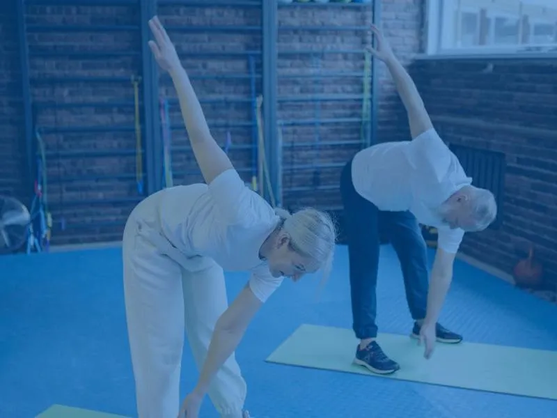a man and a woman exercising on yoga mats